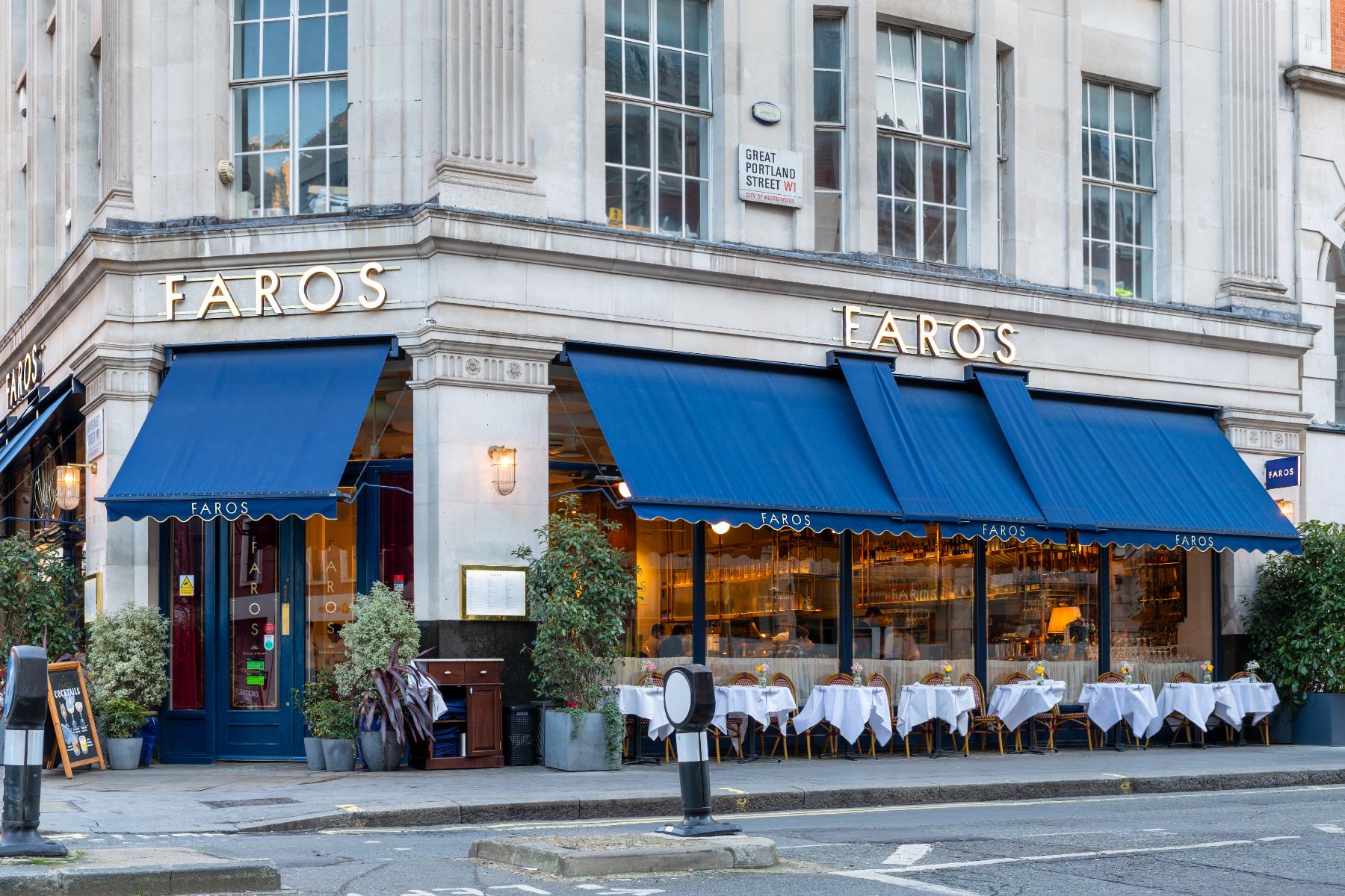Corner elevation of the Faros shopfront with gilded lettering above the glazing